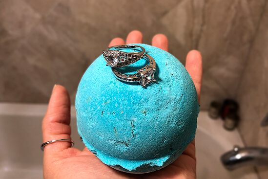 A young woman holding our Bath Bombs with the ring on top